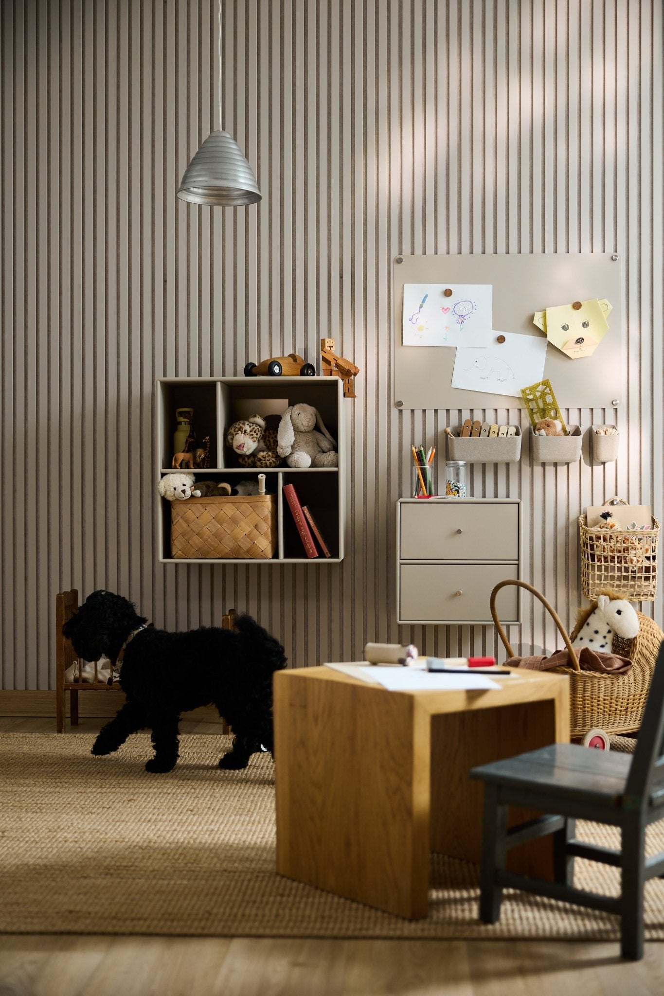 Playroom with a black dog, Danish furniture, toys, art supplies, kids’ drawings, natural light, and a WoodUpp Arka Open Cabinet.